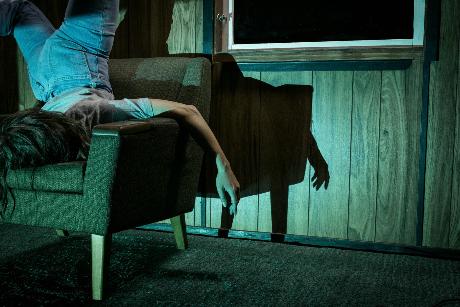 A woman upside down on a chair