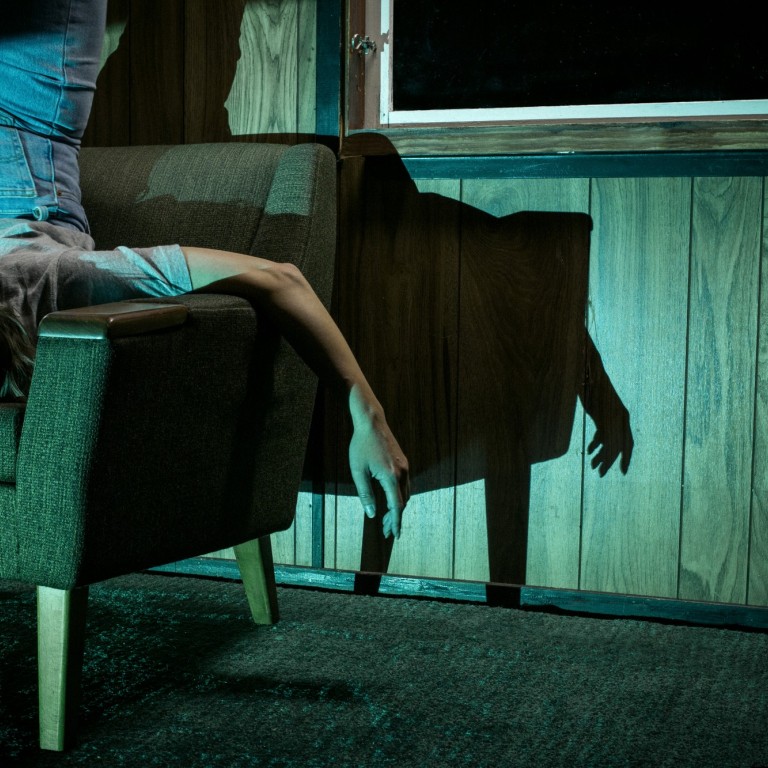 A woman upside down on a chair