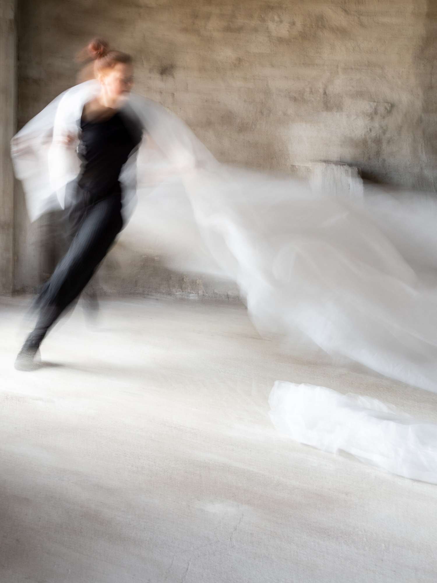 A running dancer with a white fabric