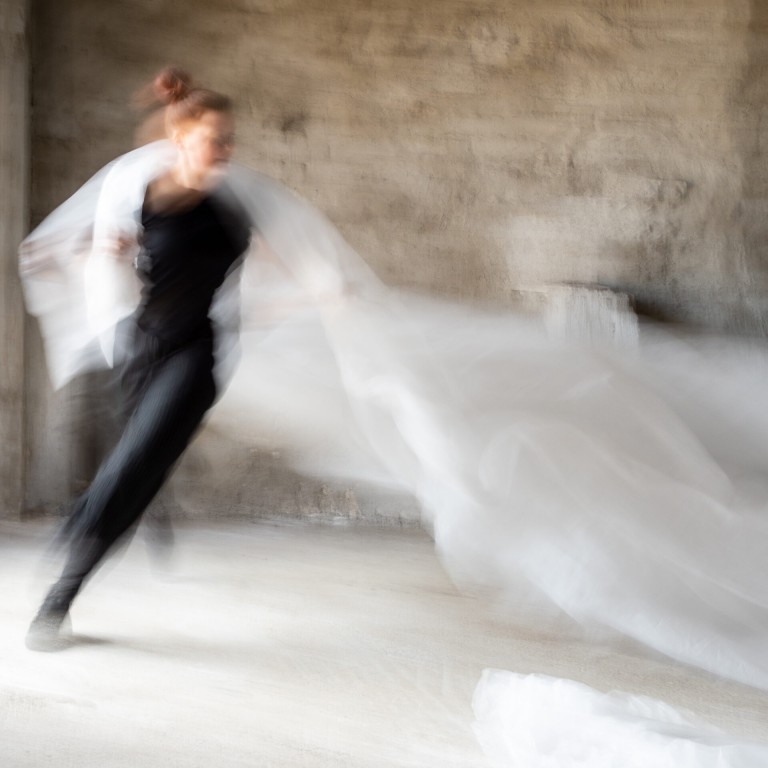A running dancer with a white fabric