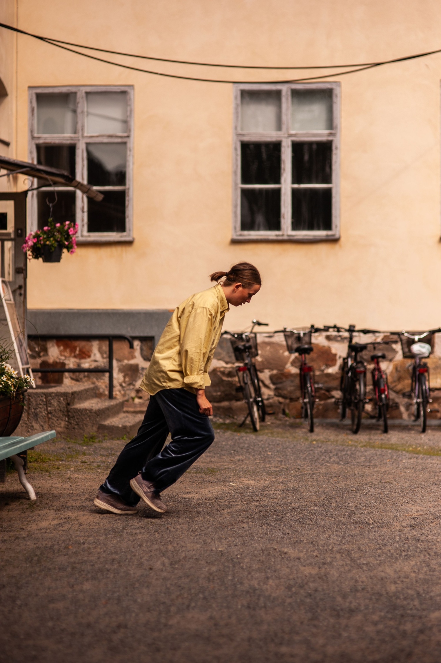 A woman dances in the yard