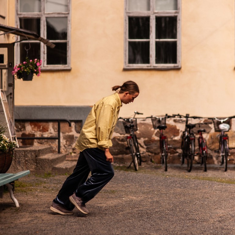 A woman dances in the yard