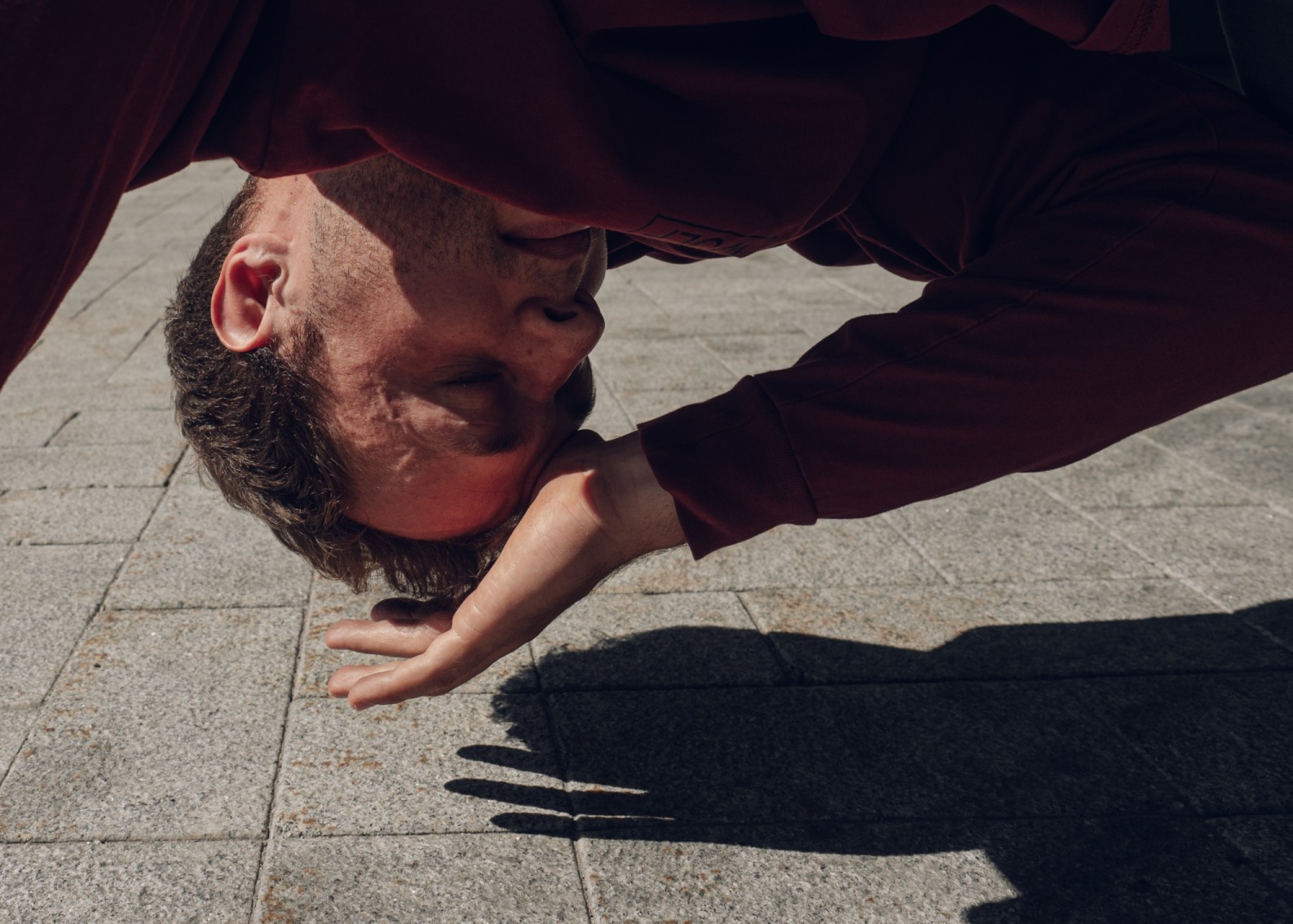 A man is upside down near the ground