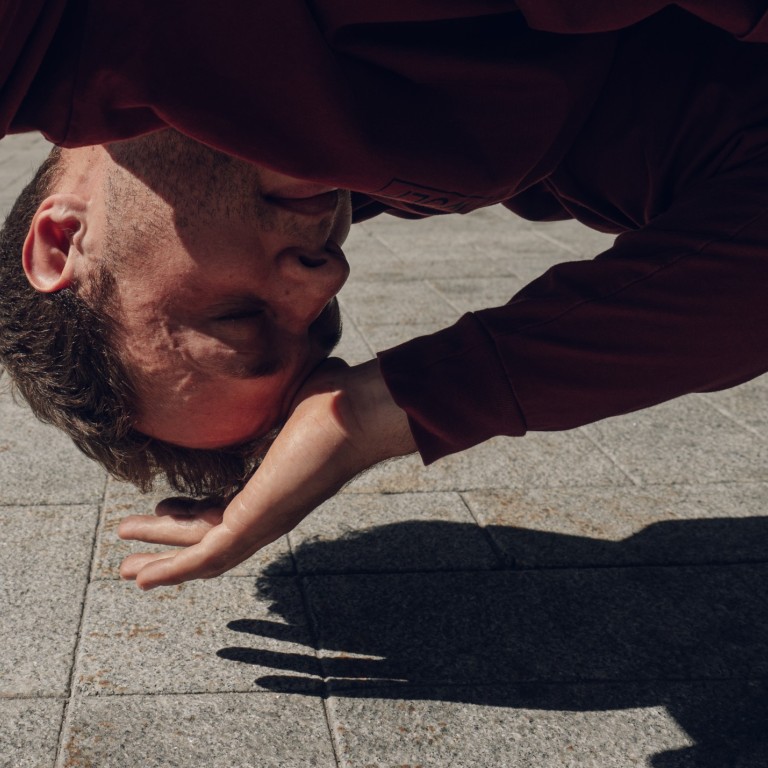 A man is upside down near the ground