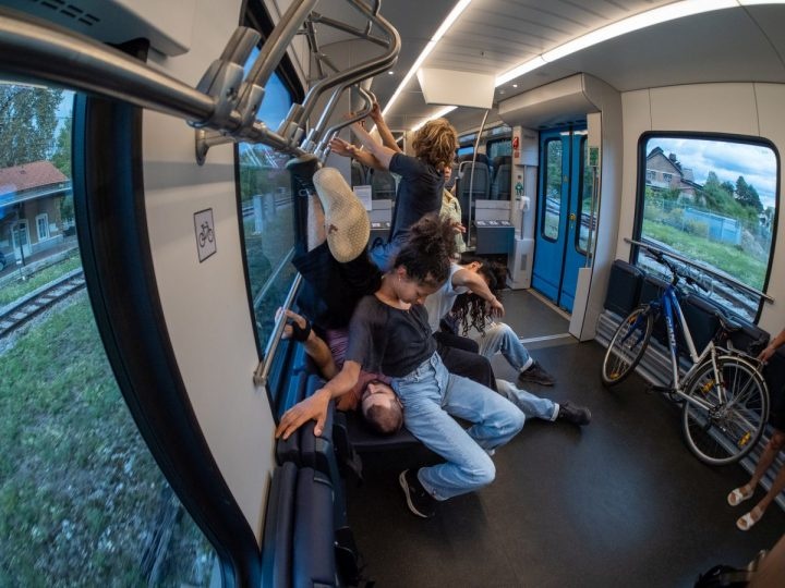 Dancers climbing on each other on a local train