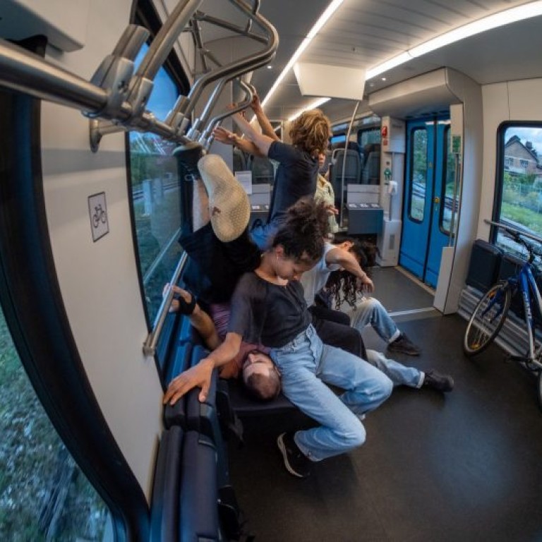 Dancers climbing on each other on a local train
