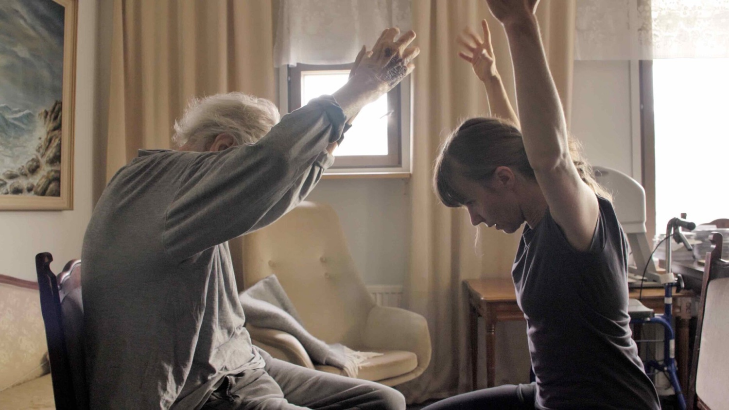 A woman and an aged man dancing with their hands