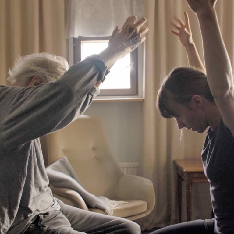 A woman and an aged man dancing with their hands
