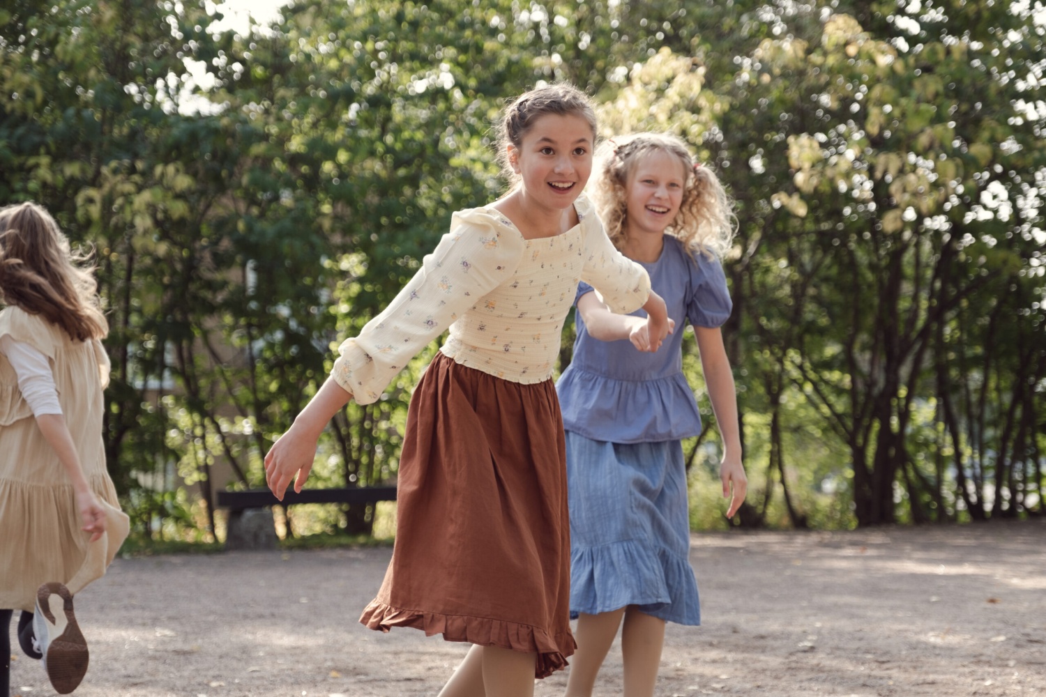 Two young girls holding hands