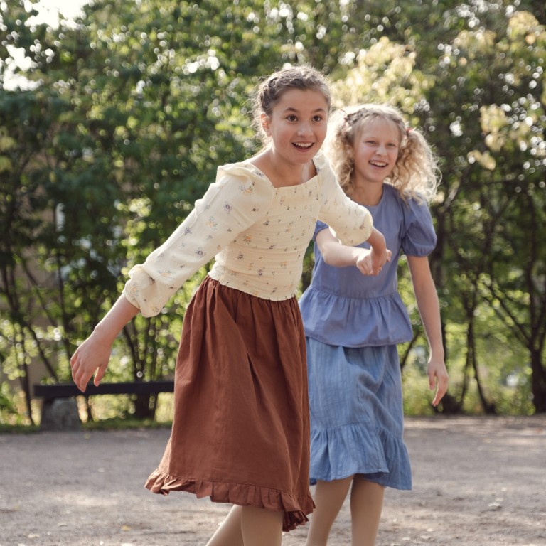 Two young girls holding hands