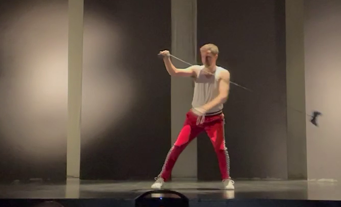 Man in red pants throwing a game control