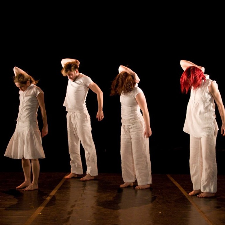 Four women dressed in white standin in a row