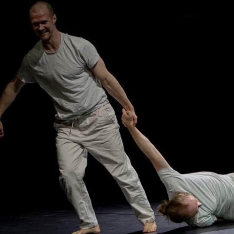 a man dressed in white dragging another