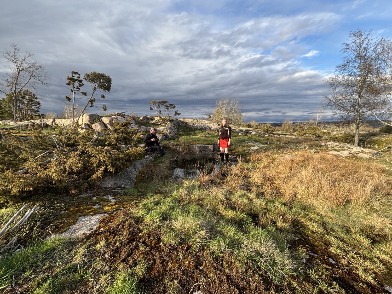 Nainen seisoo avarassa luontomaisemassa
