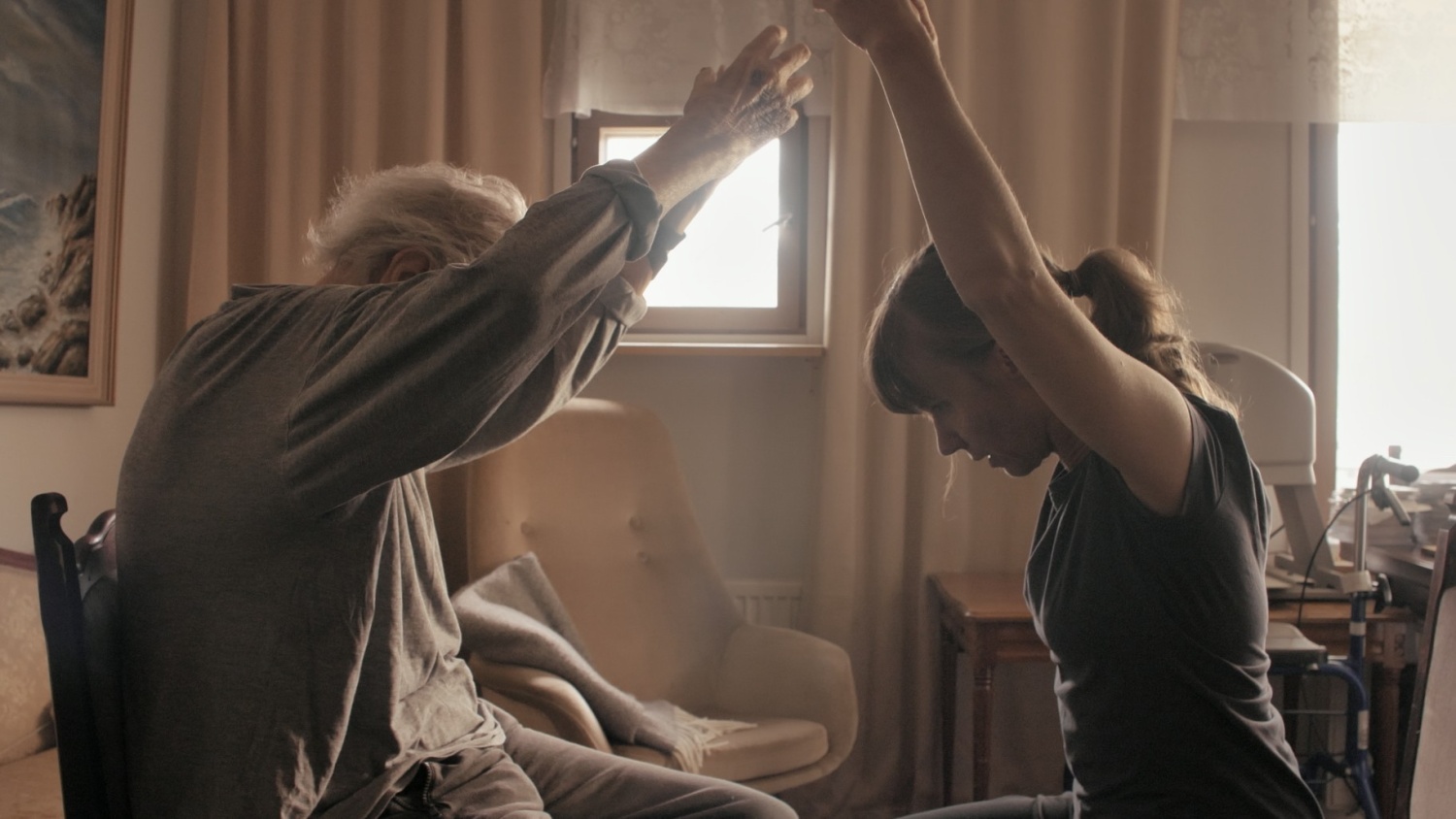 An old man and a woman dance with their hands